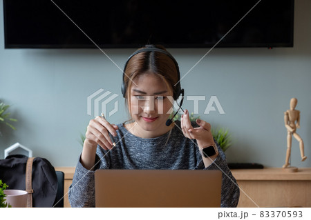 Shot smiling asian woman freelancer wearing headset, communicating with client via video computer call. Millennial pleasant professional female tutor giving online language class Shot smiling asian woman freelancer wearing headset, communicating with client via video computer call. Millennial pleasant professional female tutor giving online language class 83370593