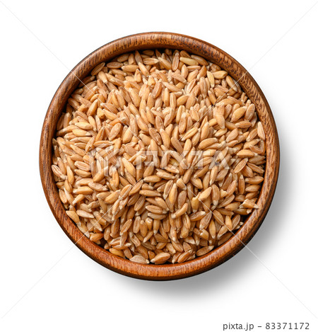 Wholegrain spelt farro in wooden bowl isolated on brown background. Top view. Wholegrain spelt farro in wooden bowl isolated on brown background. Top view. 83371172