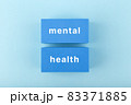 Mental health text written on dark blue rectangles in the middle of bright blue background 83371885