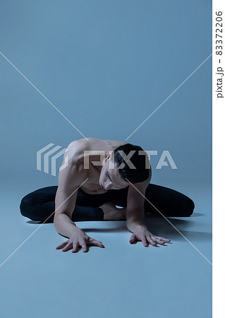 Young and graceful male ballet dancer in art performance isolated on old navy studio background. Art, motion, action, flexibility, inspiration concept. Young and graceful male ballet dancer in art performance isolated on old navy studio background. Art, motion, action, flexibility, inspiration concept. 83372206