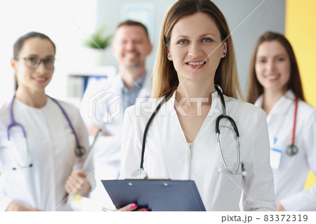Portrait of successful female doctor on background of colleagues 83372319
