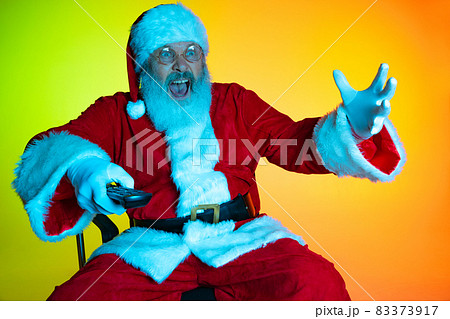 Portrait of senior man, surprised Santa Claus sitting and watching movie at cinema, indoors. Happy New Year 2022, Christmas concept Portrait of senior man, surprised Santa Claus sitting and watching movie at cinema, indoors. Happy New Year 2022, Christmas concept 83373917