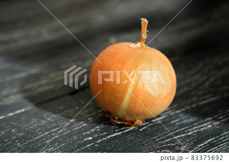 onion bulb on a rustic wooden grey table. onion bulb on a rustic wooden grey table. 83375692