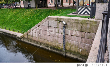 Stone pillar and water level meter on the river Stone pillar and water level meter on the river 83376401