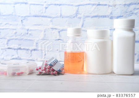 many medical pill container on table  83376557
