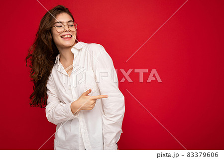 Portrait of beautiful positive cheerful cute smiling young brunette woman in casual white shirt and Portrait of beautiful positive cheerful cute smiling young brunette woman in casual white shirt and 83379606