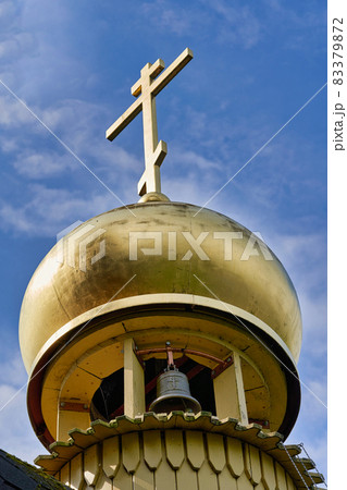 Fragment of the bell tower of a Christian church with a blue roof Fragment of the bell tower of a Christian church with a blue roof 83379872
