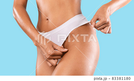 Unrecognizable Lady Posing In Panties Isolated On Blue Studio Background 83381180