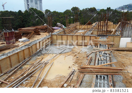 KUALA LUMPUR, MALAYSIA -MARCH 29, 2021: Building ground beam under construction at the site using timber plywood as the formwork. The concrete was reinforced by the steel reinforcement bar KUALA LUMPUR, MALAYSIA -MARCH 29, 2021: Building ground beam under construction at the site using timber plywood as the formwork. The concrete was reinforced by the steel reinforcement bar 83381521