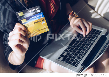 Close up of business woman holding credit card during using laptop for online shopping. Online shopping is the process of buying goods and services from merchants over the Internet. 83382339