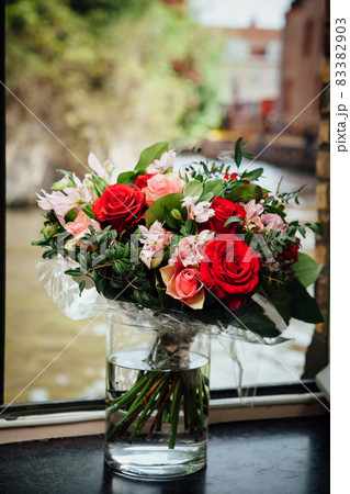 flowers bouquet on the window with water background flowers bouquet on the window with water background 83382903