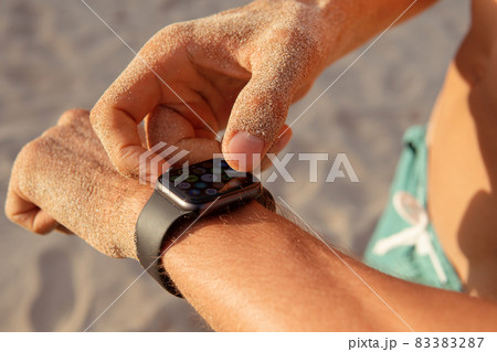 a man checks his pulse after training a man checks his pulse after training 83383287