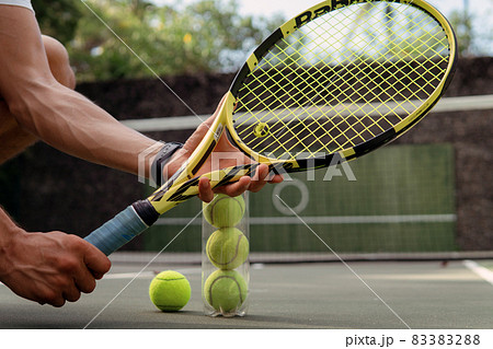 close-up. male hands holding tennis racket and balls close-up. male hands holding tennis racket and balls 83383288