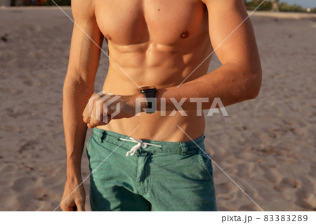 a man checks his pulse after training 83383289