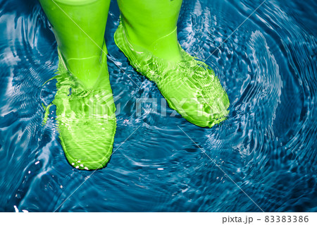 green rubber boots in the water 83383386