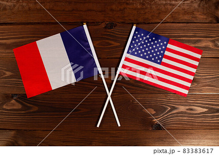 Flag of France and flag of USA crossed with each other. The image illustrates the relationship between countries. Photography for video news on TV and articles on the Internet and media. Flag of France and flag of USA crossed with each other. The image illustrates the relationship between countries. Photography for video news on TV and articles on the Internet and media. 83383617