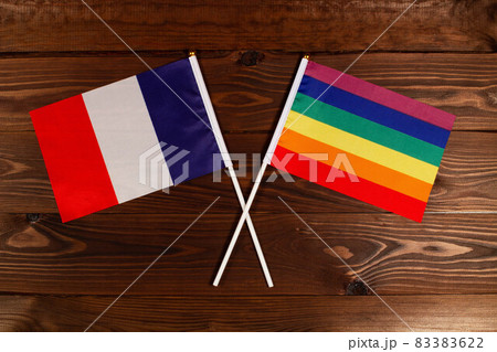 Flag of France and flag of LGBT crossed with each other. The image illustrates the relationship between countries. Photography for video news on TV and articles on the Internet and media. 83383622