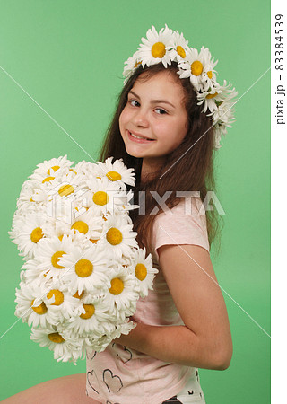 Beautiful girl with chamomile wreath 83384539