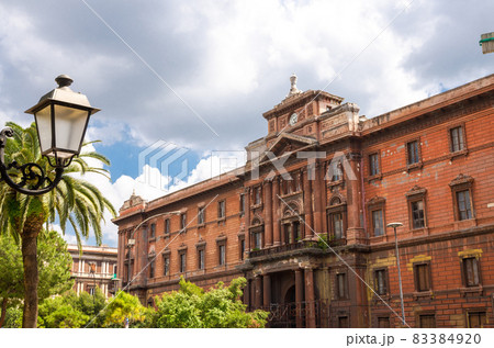 ld red brown brick building with clock watch, Taranto, Puglia, Italy 83384920