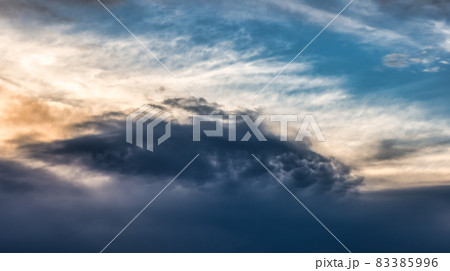 View of dark cloudscape during dramatic sunset on the ocean coast View of dark cloudscape during dramatic sunset on the ocean coast 83385996