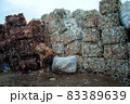 Bundle of pressed plastic bottles prepared for a garbage recycling on waste recycling plant. Camera moves forward. Pollution problem. Stabilized video 83389639