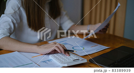 A businesswoman examines a financial chart in order to make arrangements. Investment concept for a business fund. A businesswoman examines a financial chart in order to make arrangements. Investment concept for a business fund. 83389939
