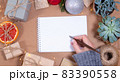 Woman holding calligraphic pen Christmas greeting card template in craft style. Empty paper  83390558