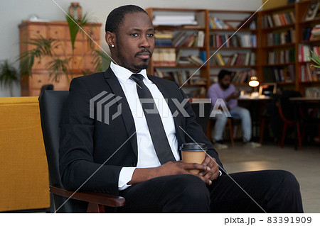 African american businessman with coffee in a hotel cafe African american businessman with coffee in a hotel cafe 83391909