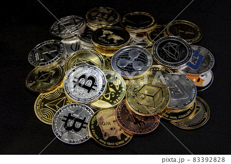 Horizontal view of cryptocurrency tokens, including Bitcoin, Ethererum Ripple, and Litecoin saw from above on black background 83392828