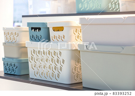 Plastic containers on a shelf on a rack for organizing home space, order and interior, sale of household goods Plastic containers on a shelf on a rack for organizing home space, order and interior, sale of household goods 83393252