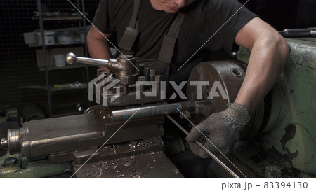 Metal spiral production on lathe in workshop Metal spiral production on lathe in workshop 83394130