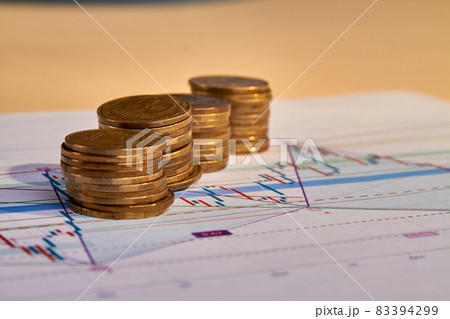 Stacks of money coins with graph paper. 83394299