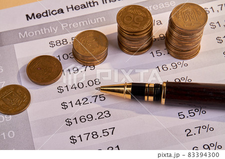 Medical health insurance bill with pen and coins. 83394300