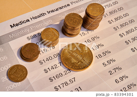 Medical health insurance bill and many golden coins. 83394301