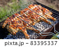 Chicken grilled on a charcoal barbeque brazier 83395337