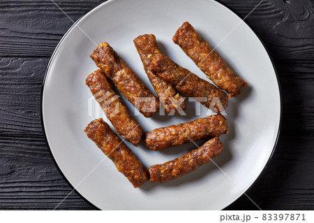 cevapcici, grilled balkan sausages on a plate cevapcici, grilled balkan sausages on a plate 83397871