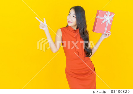 Portrait beautiful young asian woman smile with red gift box Portrait beautiful young asian woman smile with red gift box 83400329