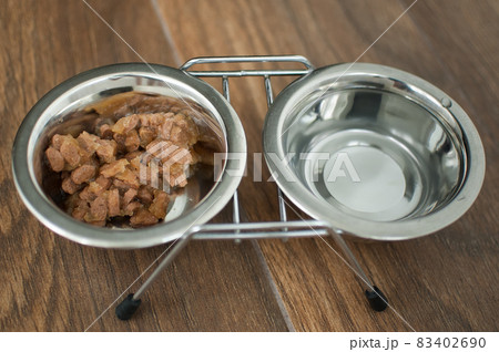 Wet food for dogs and cats in a bowl close up 83402690