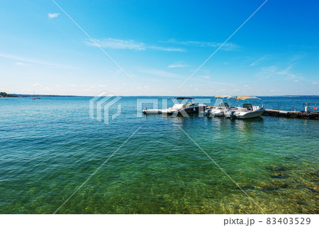 Small Speed Boats Moored on the Coast of Lake Garda - Bardolino Veneto Italy 83403529