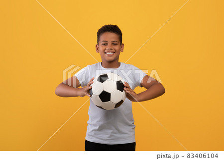 Cheerful black school boy holding soccer ball 83406104