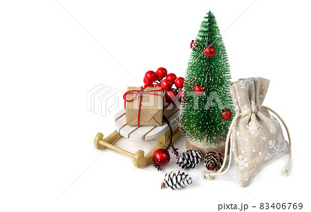 Miniature Christmas tree with Christmas gifts on the sleigh isolated on white. 83406769