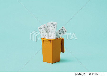 dustbin full of used covid-19 rapid test devices 83407508