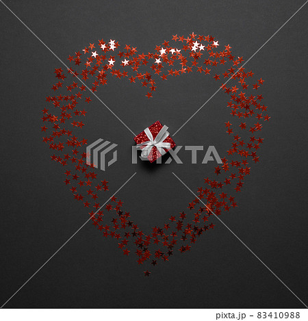 Romantic card with a small gift and a shiny heart. Festive flatlay composition Romantic card with a small gift and a shiny heart. Festive flatlay composition 83410988