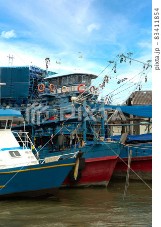 A group of fishing boats moored at the pier in Southern of Thailand. 83411854