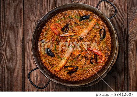 Seafood paella on rustic wood Seafood paella on rustic wood 83412007