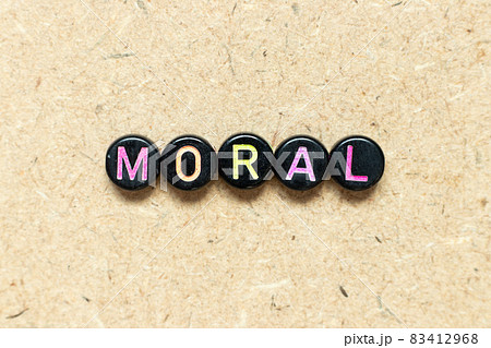 Black color round bead in word moral on wood background 83412968