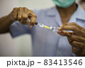 Close-up of doctors, nurses, sucking vaccines from bottles, preparing to vaccinate against and cure from coronavirus, covid-19, flu, infection. Medical concept of vaccination. 83413546
