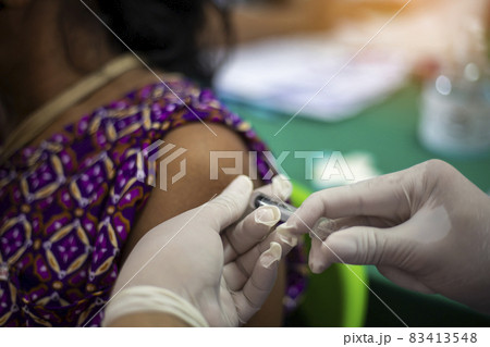 Close-up of doctors, nurses, vaccinating against and treating from coronavirus, covid-19, flu, infection. Medical concept of vaccination. 83413548