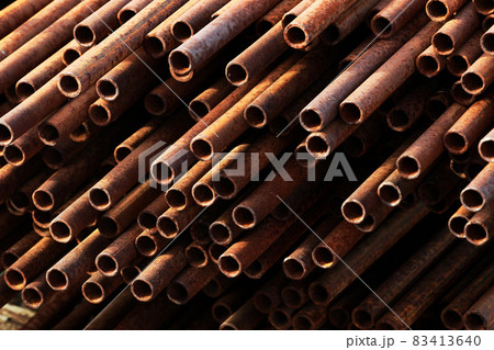 Many small-diameter metal pipes for gasification and construction lie in a stack in an open 83413640