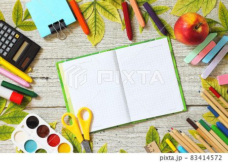 Back to school. Flatlay background. Table with autumn leaves, note pad, apple  and school supplies. Free space for your text. 83414572